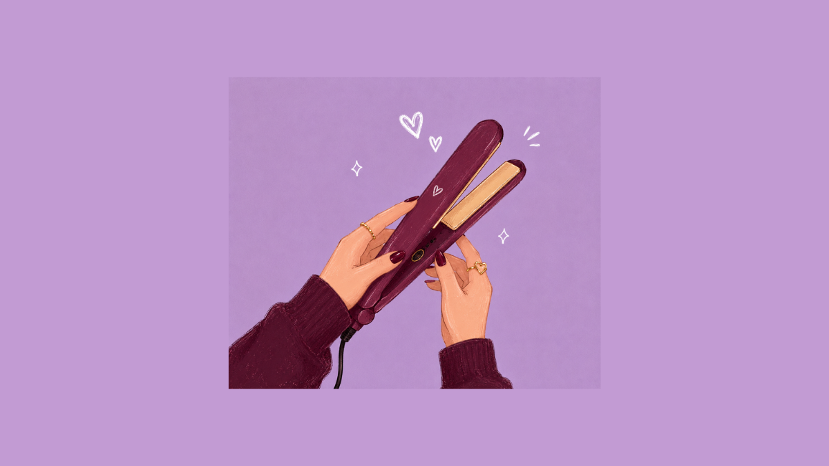 A person's hand holds a sleek flat iron near a bathroom sink, ready for hair styling.
