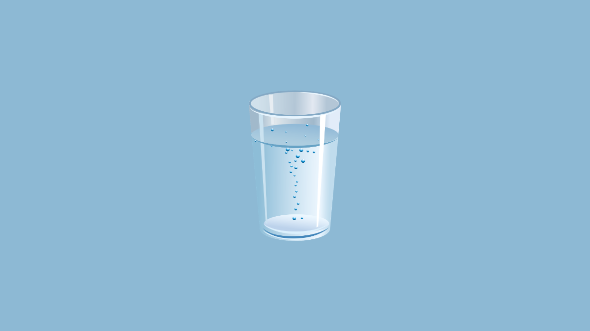 A refreshing glass of water with lemon slices on a bright kitchen counter, symbolizing skin hydration.